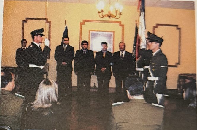 Nuevos alguaciles de pie en la ceremonia de juramento, junto al estandarte